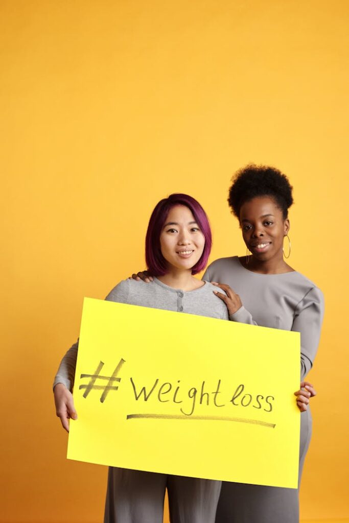 Two women promoting healthy lifestyle with weight loss message on a bold yellow background.